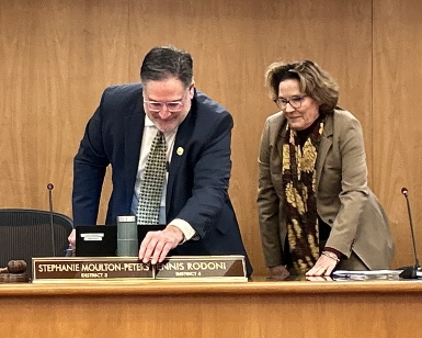 Dennis Rodoni (left) switches seats and nameplates with Stephanie Moulton-Peters during the January 9 meeting.