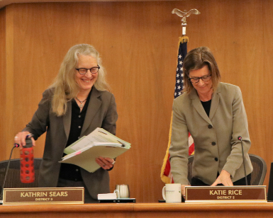 Supervisor Kate Sears (left) and Supervisor Katie Rice gather their belongings and prepare to switch chairs at the Board of Supervisors meeting on January 14, 2020.