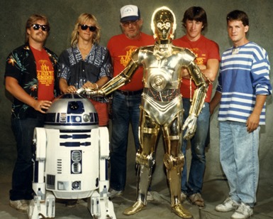 Five men pose with C3PO and R2D2 droids from the 'Star Wars' movies at the 1988 Marin County Fair.