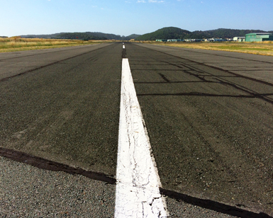 A closeup view of the pavement on the Gnoss Field runway