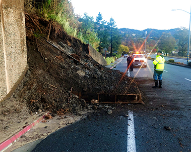 Workers check a mudslide on Point San Pedro Road.