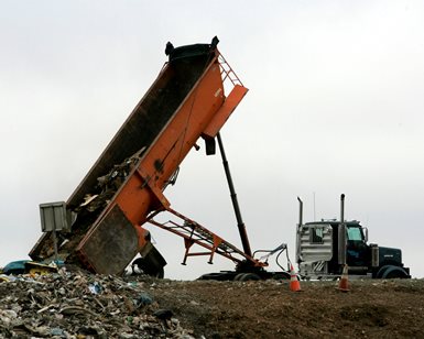 A dump truck releases its load at Redwood Landfill near Novato.