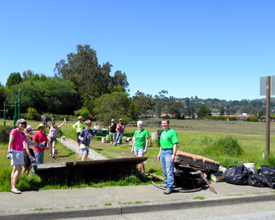 About 10 volunteers are shown at a past trash collection event.