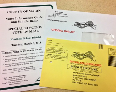 A ballot and envelope sit on a table