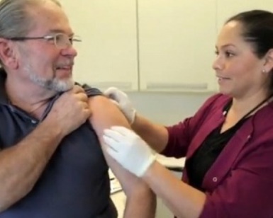 A nurse gives a man a flu shot.