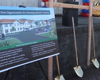 A sign of about 4 feet wide and 3 feet tall shows an architectural rendering of the veterans housing project being planned for Novato.