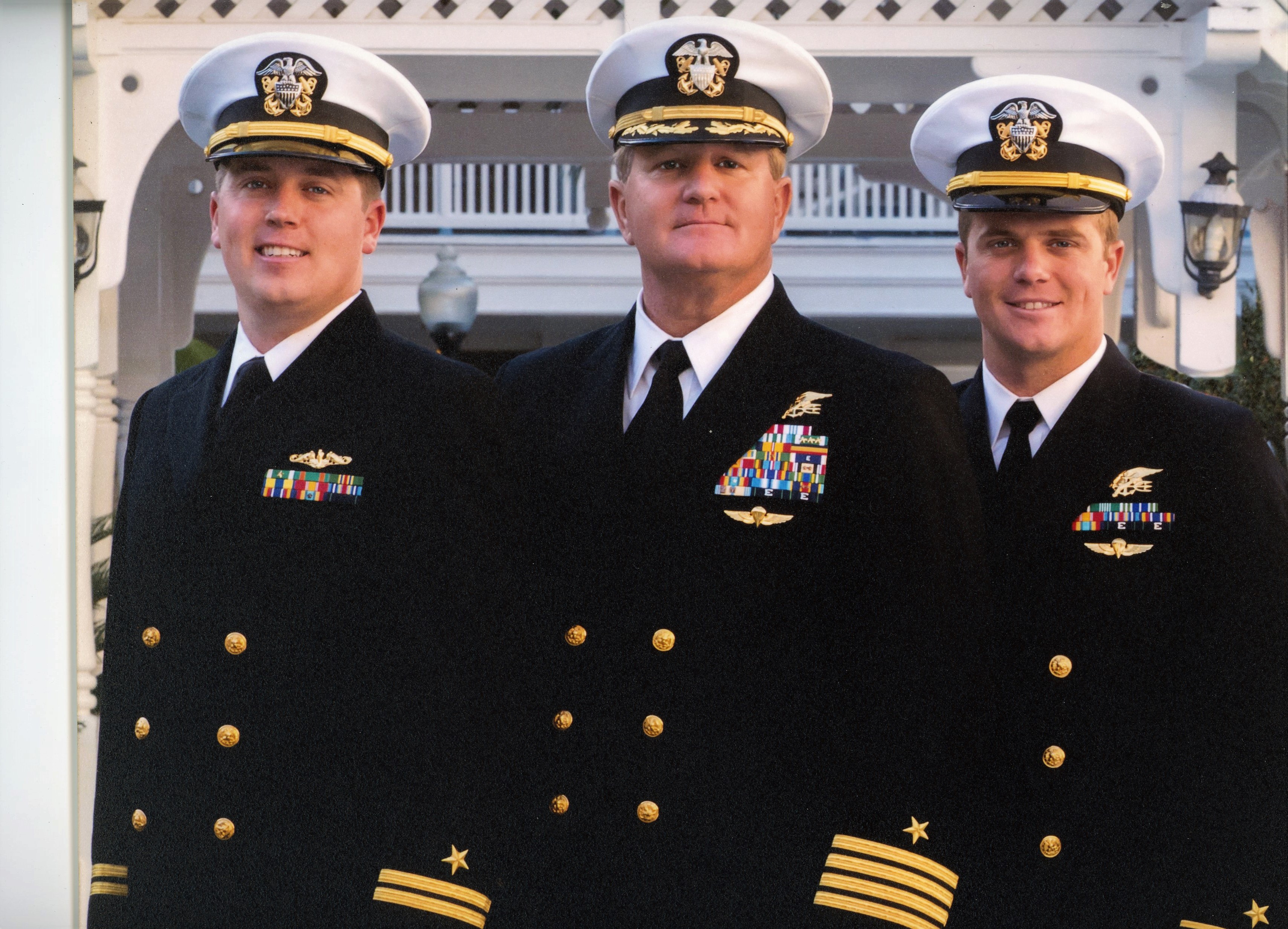 Retired Navy Captain Richard Sisk stands with his sons Brian and Sean, who are also in Navy uniforms.