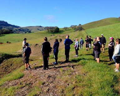 A parks ranger talks to about 20 people at the site of the future bike park near Novato.