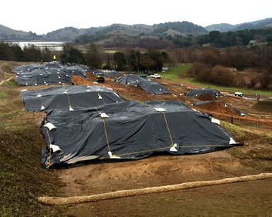 Tarps cover parts of the Stafford Lake Bike Park to prevent erosion.