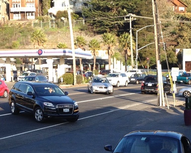 Cars and SUVs drive along Shoreline Highway in the busy Tam Junction area.