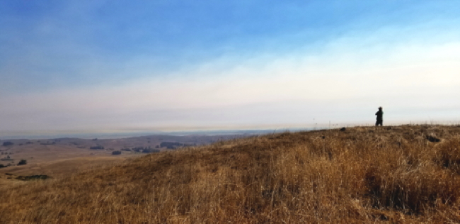 Rancher in Marin County overlooking dry hills and smoke filled valleys