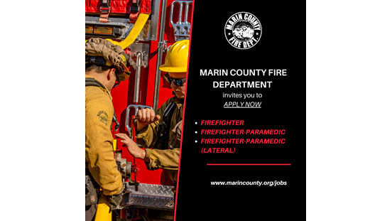 Two firefighters in front of an engine