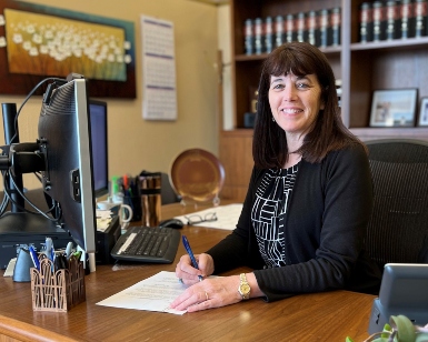 Marin County Assessor-Recorder-County Clerk Shelly Scott smiles while sitting at her desk
