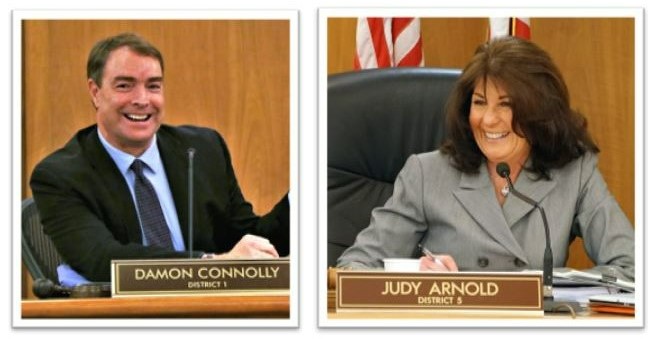 Side-by-side photos of Damon Connolly and Judy Arnold sitting at their desks in the Board chamber.