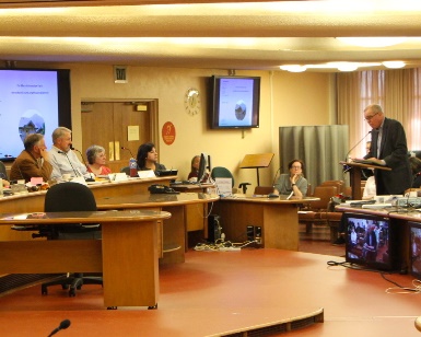 A member of the public speaks into a microphone while members of the Planning Commission listen at a recent meeting.