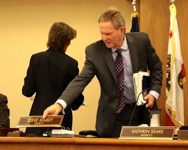 Supervisor Steve Kinsey places his nameplate at the center of the Board of Supervisors dais after being voted as Board President on January 5, 2016.
