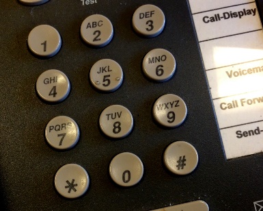 A closeup view of the numbers on a telephone.