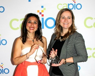 Dr. Rocio Hernandez (left) holds the award for the Viva Marin report and Public Information Officer Laine Hendricks hold the award for the State of the County 2016 report.