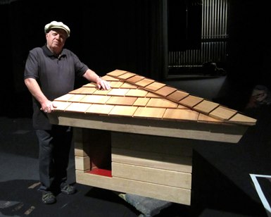 Jim Berger poses next to the doghouse he donated to the County of Marin.