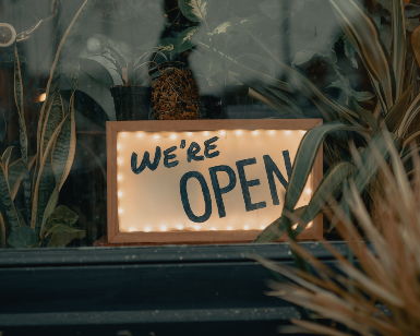 An "open" sign in a business' front window.