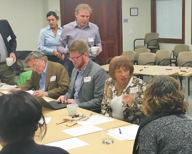 Eight people are shown around a table at the first Drawdown: Marin Steering Committee meeting.