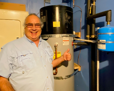 Fabrice Florin of Mill Valley stands next to his new high-efficiency water heater.