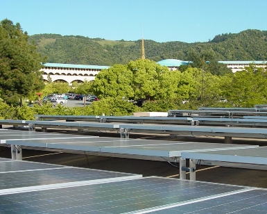 A view of solar panels on a county building with the Civic Center in the background.