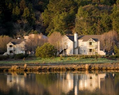 A view across a pond of the Edgewater Place affordable housing complex in Larkspur.