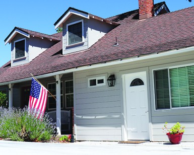 The front of home in San Rafael is shown with the main front door on the left and the accessory unit front door on the right.