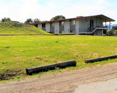 An exterior view of a building and an open field on the property owned by North Coast Land Holdings.