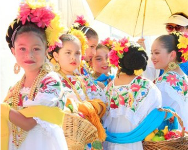 Children dressed in traditional Latino dresses.