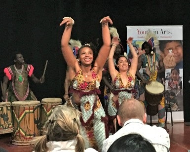 Several dancers wear African costumes as they perform in front of drummers at a past Marin County Fair.