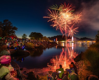Fairgoers watch fireworks from the edge of the lagoon at the Marin County Fairgrounds.