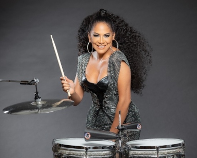 Publicity photo for percussionist Sheila E, shown with drums
