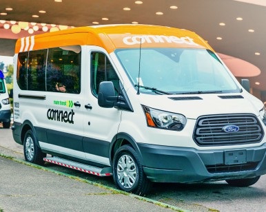 A Marin Transit Connect shuttle bus parked outside the Marin County Civic Center.