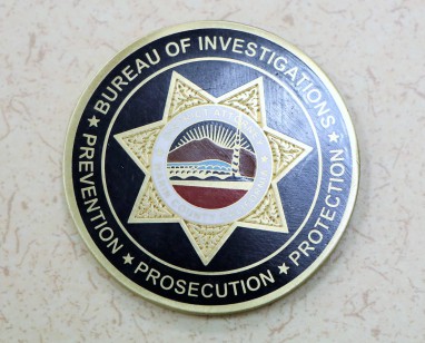 A close-up view of a DA's Office challenge coin.