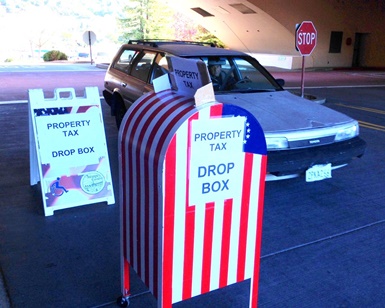 A driver pulls up in front of a property tax dropoff box outside the Marin Civic Center.