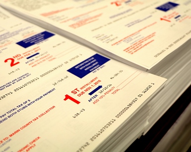 A close-up view of a stack of property tax bills about to be mailed.