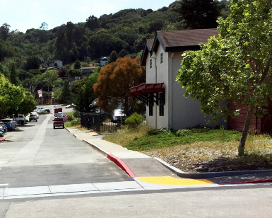 A view of a road intersection that shows new disabled accessible curb ramps.