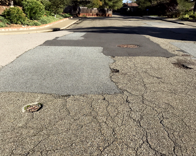 A closeup view of road pavement that is in need of rehabilitation.