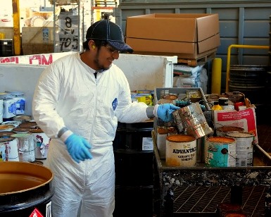 A man handles old paint cans at the Household Hazardous Waste Facility in San Rafael.