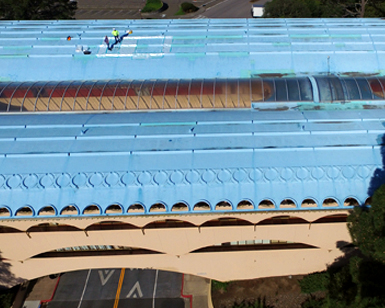 In a view from above the Civic Center, construction workers assess the deteriorating roof.