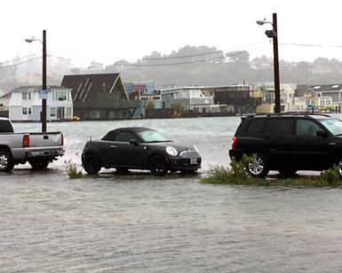 Cars are stranded on a thin slice of land between Richardson Bay and a flooded roadway near Gate 6 in Sausalito