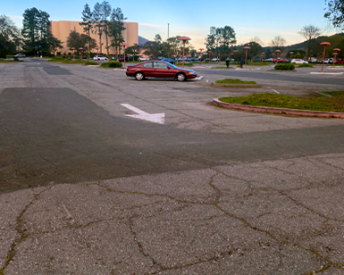 A closeup view of the pavement at the Veterans' Memorial Auditorium parking lot show deterioration.