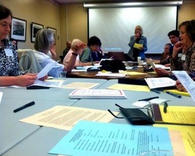 A photo from an Elections Advisory Committee meeting, showing participants around a table.