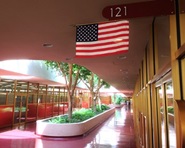 An exterior view of the Marin County Elections Department, with American flag hanging in front of the door.