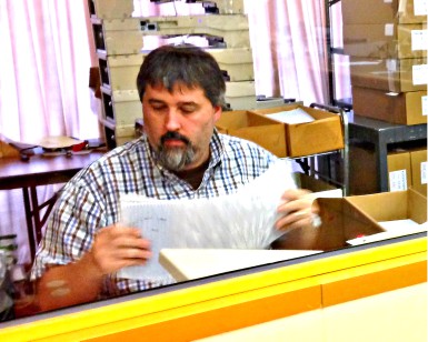 Elections worker Tony Aquilino feeds ballots into a counting machine inside the Marin County Elections Department.