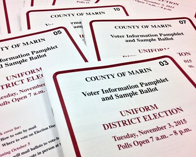 A close-up view of voter pamphlets laid out on a table.