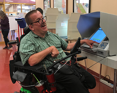 Peter Mendoza of the Marin Center for Independent Living casts his ballot at the Marin County Elections Department.