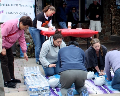 Several trainers help teach people how to do hands-only CPR at a past Don't Miss a Beat event.
